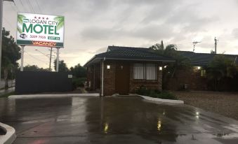 "a motel with a sign that says "" ocean city motel "" and a rainy day in the background" at Logan City Motor Inn