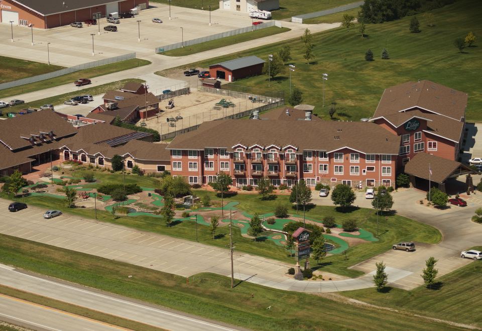 an aerial view of a large apartment complex with multiple buildings , including a conference center and a building with a green lawn at Norfolk Lodge & Suites, Ascend Hotel Collection