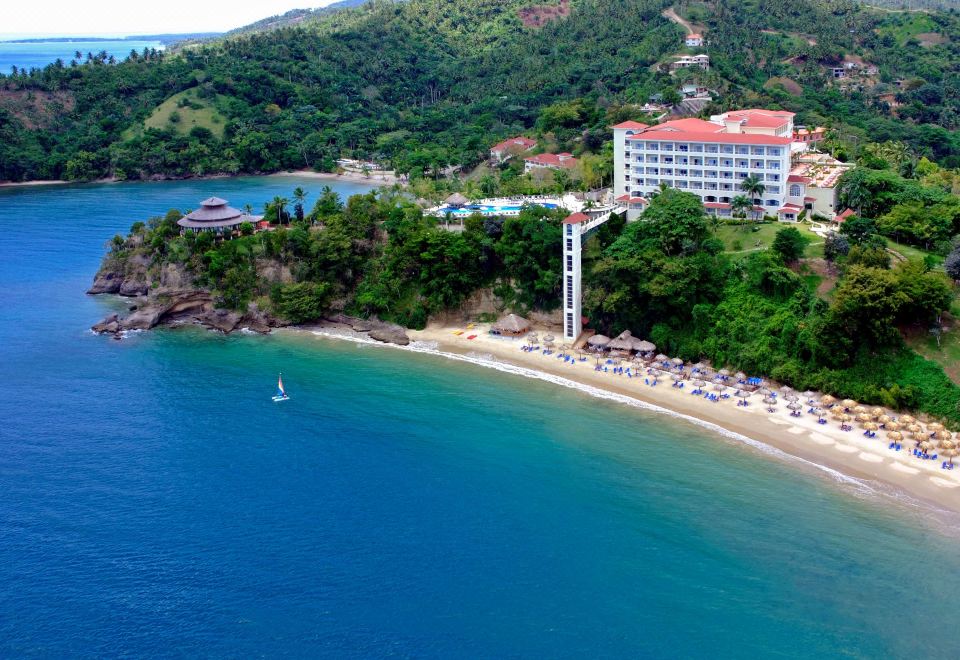 aerial view of a sandy beach near a hotel , with people enjoying their time in the water at Bahia Principe Grand Cayacoa