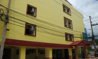 a yellow building with a red roof and two windows is shown from the front at Sirasit 999 Mansion