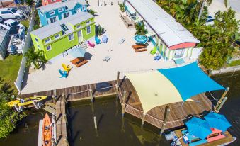 an aerial view of a boat dock with multiple boats docked and a building in the background at Matlacha Tiny Village