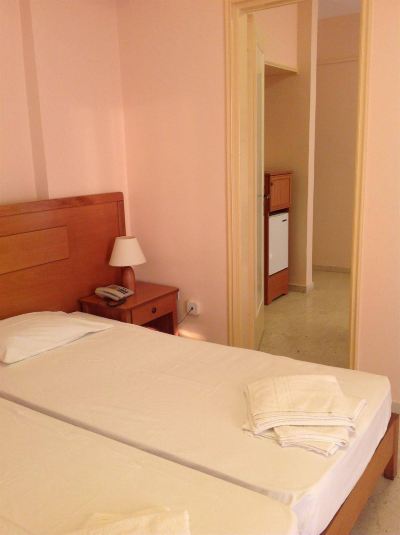 a hotel room with two beds , one on the left and one on the right side of the room at Hotel Summery