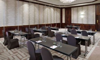 a conference room set up for a meeting , with chairs arranged in rows and a podium in the center at Amman Marriott Hotel