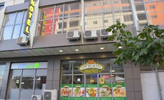 "a storefront with a green sign that says "" top quality "" and chinese characters , along with air conditioners and windows" at Comfort Hotel