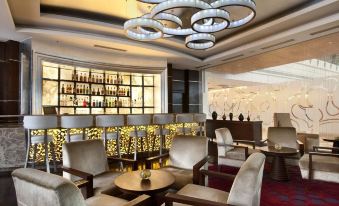 a modern bar area with various chairs and tables , creating an inviting atmosphere for patrons at Hyatt Centric Janakpuri New Delhi