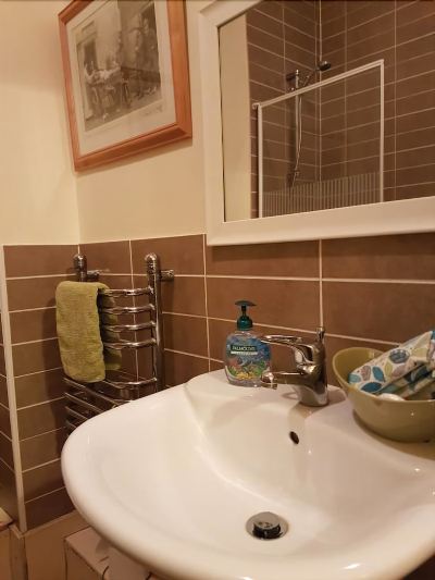 a bathroom sink with a white basin and chrome faucet , next to a mirror and towels at Knights