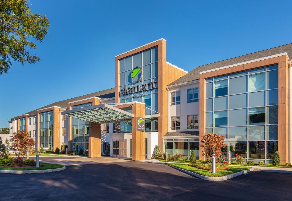 "a large office building with a green sign that reads "" carelife plus .""." at Element Chelmsford