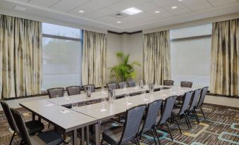 a conference room with a long table , chairs , and large windows , ready for a meeting at Residence Inn Bangor
