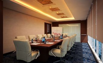 a large conference room with a long wooden table , multiple chairs , and various electronic devices at Best Western Premier la Grande Hotel