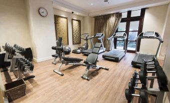 a well - equipped gym with a variety of exercise equipment , including treadmills , weight machines , and benches at Palazzo Hotel
