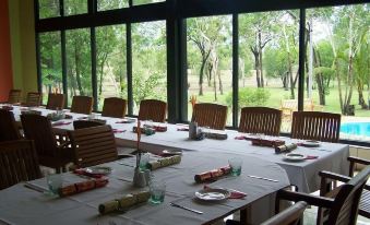 a long dining table set up for a formal event , with multiple chairs arranged around it at Breeze Holiday Parks - Mary River