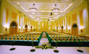 A large ballroom is set up with rows of green chairs for an event or function at Hanoi Daewoo Hotel