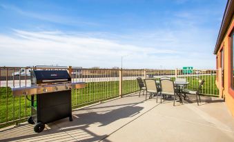 a patio area with a grill , chairs , and tables , providing a comfortable outdoor space for relaxation and socializing at Comfort Inn & Suites Chillicothe