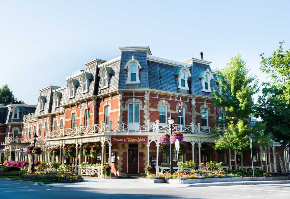 "a large brick building with multiple balconies and a sign that reads "" the victoria inn ""." at Prince of Wales