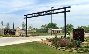 "a large sign with the word "" fort worth "" written on it , standing in front of a field and surrounded by grass" at Sendero Ranch