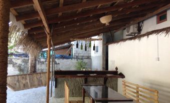 a wooden terrace with a table and chairs , providing a comfortable outdoor seating area for guests at Paradise Lagoon