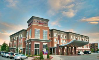 "a large brick building with a sign that reads "" hilton garden inn "" prominently displayed on the front of the building" at SpringHill Suites Pueblo Downtown