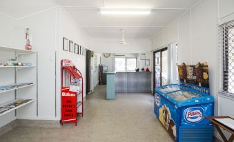 a hallway with a red and blue refrigerator on the left side and a vending machine on the right side at Big4 Townsville Gateway Holiday Park