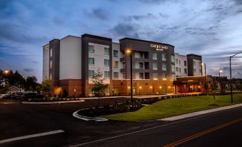 an exterior view of a fairfield inn & suites hotel building at night , with the hotel lit up at night at Courtyard Columbia Cayce