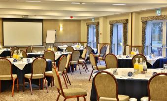 a conference room with rows of chairs and tables set up for a meeting or event at Manor House Hotel & Spa, Alsager