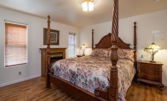 a large bed with a wooden headboard and footboard is in a bedroom with a wooden floor at Inside Yosemite Lower Cascades
