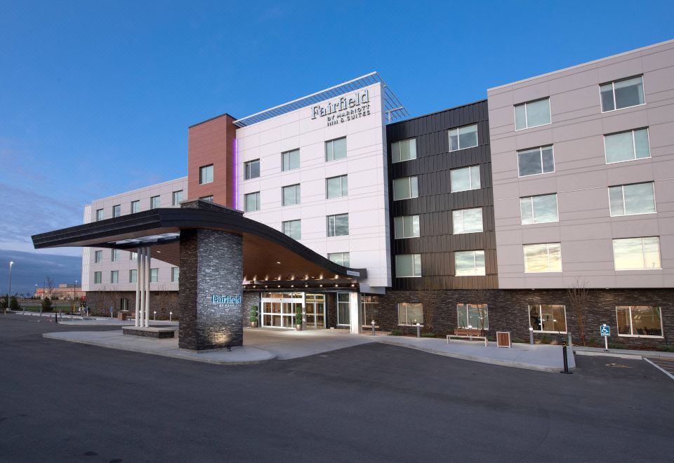 "a large hotel building with a modern design and the name "" fairfield inn & suites "" displayed on its facade" at Fairfield by Marriott Edmonton International Airport