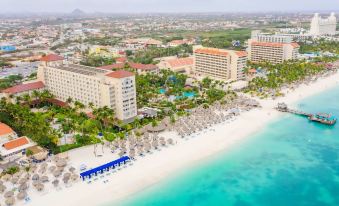 a bird 's eye view of a beachfront resort with multiple buildings and umbrellas on the sand at Hyatt Regency Aruba Resort, Spa and Casino
