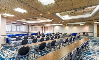 a large conference room with multiple rows of chairs arranged in a semicircle , providing seating for attendees at Crystal Coast Oceanfront Hotel