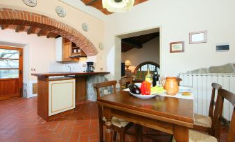 a kitchen with a dining table and chairs , as well as a sink and oven at Arco