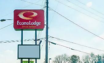 a econo lodge hotel sign is displayed on a pole in front of power lines at Economy Inn & Suites