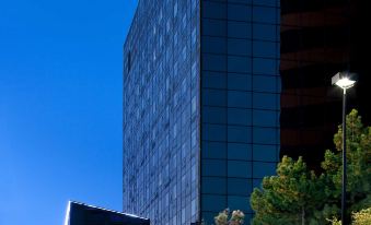 a modern building with a large glass facade and a hyatt place sign on the side at Hyatt Place Denver Cherry Creek