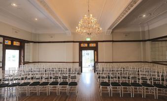 a large room with rows of chairs arranged in a symmetrical fashion , possibly for a wedding or conference at The Robertson Hotel