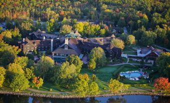 a bird 's eye view of a large resort with multiple buildings , trees , and a lake at Fairmont le Château Montebello