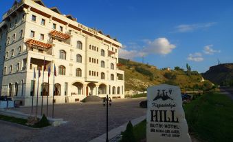 "a large white building with a sign that reads "" ranaskelana hill "" is surrounded by trees and grass" at Kapadokya Hill Hotel & Spa (12+)