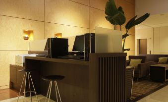 a hotel lobby with two reception desks , one on the left and one on the right at Mitsui Garden Hotel Okayama