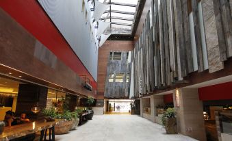 The large building features wood paneled ceilings on both sides of its lobby and main entrance at The Salisbury YMCA of Hong Kong