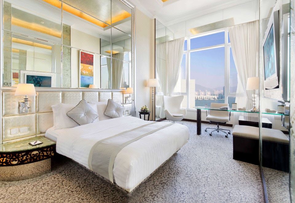 elegant wooden nightstand with a lamp on top, creating a serene and bright atmosphere at Regal Hongkong Hotel