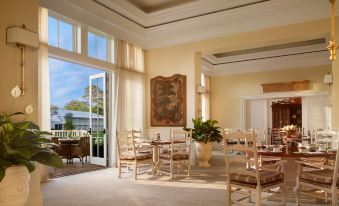 a spacious living room with large windows , white walls , and wooden furniture , creating a luxurious and inviting atmosphere at Montage Palmetto Bluff