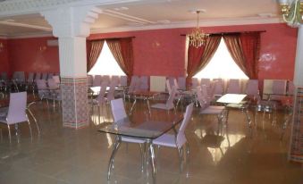 a large dining room with multiple tables and chairs , creating a pleasant atmosphere for guests at Pomaria