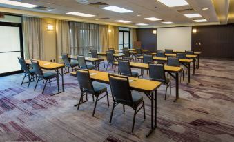 a large conference room with rows of chairs arranged in a semicircle around a table at Courtyard by Marriott Scranton Montage Mountain