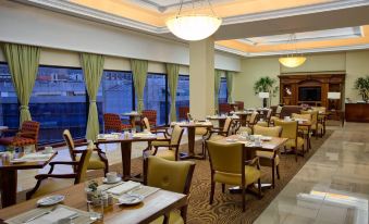 a well - lit dining room with multiple tables and chairs arranged for a group of people at JW Marriott Hotel Caracas