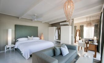 a modern bedroom with a large bed and a couch , creating a cozy and inviting atmosphere at White Pearl Resorts
