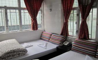 The small bedroom is furnished with double beds and single mattresses, and the windows are closed off at Delta Lounge