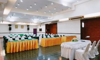 a large conference room with multiple tables and chairs arranged for a meeting or event at Baanrai Riverkkwai Resort