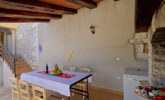 a dining room with a table and chairs set up for a meal , along with a refrigerator and microwave at Mila