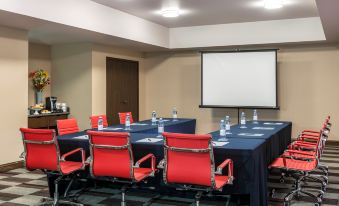 a conference room set up for a meeting , with chairs arranged in a semicircle around a table at Four Points by Sheraton Saltillo