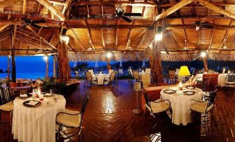 a large dining room with tables and chairs set up for a formal event , possibly a wedding reception at Punta Islita, Autograph Collection