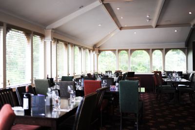 a large dining room with tables and chairs arranged for a group of people to enjoy a meal together at Village Hotel Liverpool