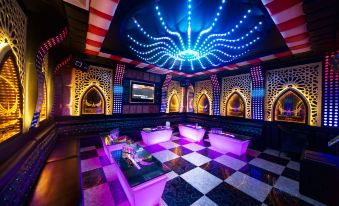 a luxurious nightclub with multiple couches , chairs , and tables , creating a warm and inviting atmosphere at Muong Thanh Grand Quang Nam