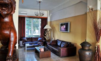 a spacious living room with multiple couches and chairs arranged in a comfortable seating area at Plaza Hotel